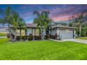 Charming single-story home with a well-manicured lawn and vibrant tropical landscaping at 2016 Chelam Way, Brandon, FL 33511