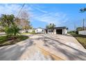 Well-maintained home with expansive driveway and lovely exterior, set on a spacious lot at 239 Freeport Ne Ave, St Petersburg, FL 33702