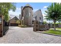 Beautiful brick home featuring an attached garage and circular paver driveway at 2902 W Fair Oaks Ave, Tampa, FL 33611