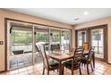 Dining room featuring tile flooring, sliding glass doors to the patio and a wooden table with six chairs at 2969 La Concha Dr, Clearwater, FL 33762