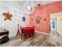 Cozy dining area features wood-look floors, unique light fixture and adjacent to the living area at 300 S Florida Ave # 600L, Tarpon Springs, FL 34689