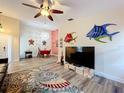 Open-concept living room showcases wood-look floors, ceiling fan and colorful decor at 300 S Florida Ave # 600L, Tarpon Springs, FL 34689