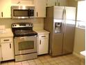 Kitchen featuring white cabinets, stainless steel appliances and neutral countertops at 3077 Casa Del Sol Cir # 207, Clearwater, FL 33761