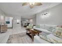 Cozy living room featuring coastal-themed decor, tile floors and ample natural light at 3114 Lake Pine Way # G1, Tarpon Springs, FL 34688