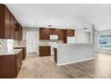 Modern kitchen featuring granite countertops, wooden cabinets, stainless steel appliances, and tiled backsplash at 3917 Casaba Loop, Valrico, FL 33596