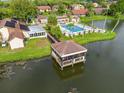 Breathtaking aerial view of community pool, clubhouse, and serene lake, perfect for relaxation at 4036 Davit Dr, New Port Richey, FL 34652