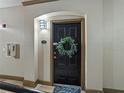 Front door with wreath and a welcome mat in a neutral-toned entryway at 4221 W Spruce St # 2302, Tampa, FL 33607