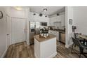 Cozy kitchen with white cabinets, stainless steel appliances, and wood-style flooring at 4221 W Spruce St # 2302, Tampa, FL 33607