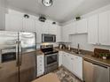 Bright kitchen with white cabinets, stainless steel appliances, and modern countertops at 4221 W Spruce St # 2302, Tampa, FL 33607