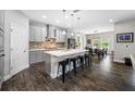 Modern kitchen boasts an island with bar seating, stainless steel appliances, and elegant pendant lighting at 4633 Ballantrae Blvd, Land O Lakes, FL 34638