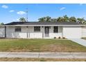 Attractive one-story home with green lawn, freshly painted exterior, and inviting walkway at 4803 Sierra Madre Dr, Tampa, FL 33634