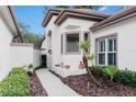 Inviting entrance with neutral colors, manicured landscape, and a walkway to the front door at 5117 Fairway One Dr, Valrico, FL 33596
