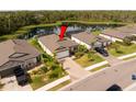 Aerial shot of a single-Gathering home with a pond view, backyard, and driveway at 5511 Badini Way, Palmetto, FL 34221