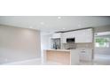 Modern kitchen featuring stainless appliances, a sleek island, and abundant cabinet space at 5625 Gateway Dr, Tampa, FL 33615