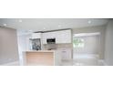 Modern kitchen featuring stainless appliances, a sleek island, and abundant cabinet space at 5625 Gateway Dr, Tampa, FL 33615
