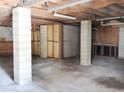 Unfinished basement with concrete pillars, floors, and exposed wooden beams on the ceiling at 5736 116Th N Ave, Pinellas Park, FL 33782