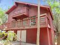 View of a two-story wooden house with a second-floor balcony and attached garage at 5736 116Th N Ave, Pinellas Park, FL 33782