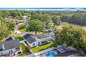 An aerial view showcasing this homes solar panels, pool, and beautiful landscaping in a residential neighborhood at 5808 Silver Moon Ave, Tampa, FL 33625