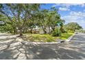 Charming single-story house on a corner lot with lush landscaping and a well-maintained lawn in a tranquil neighborhood at 5825 Oakhurst Dr, Seminole, FL 33772