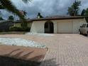 Charming home with a brick driveway, well-maintained landscaping, and an attached garage at 6409 41St N Ave, St Petersburg, FL 33709