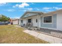 Inviting home with a cozy front porch, seating, and manicured landscaping at 6639 Winding Oak Dr, Tampa, FL 33625
