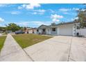 Well-maintained home with a spacious driveway and manicured lawn at 6639 Winding Oak Dr, Tampa, FL 33625