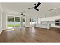Open-concept living room showcasing hardwood floors, natural light, and seamless access to the modern kitchen with marble accents at 712 W Plymouth St, Tampa, FL 33603