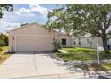Single-story home boasts a well-manicured lawn, two-car garage, and a neatly maintained landscape at 7157 Hamilton Park Blvd, Tampa, FL 33615