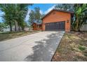 The home features a long driveway leading to a spacious two-car garage at 1004 Black Knight Dr, Valrico, FL 33594