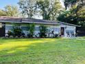 Inviting single-story home with mature landscaping and well-manicured lawn at 11107 Riverview Dr, Riverview, FL 33578