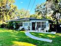 Inviting home with a well-maintained lawn, walkway, and a cozy front porch seating area at 11107 Riverview Dr, Riverview, FL 33578