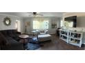 Open-concept living room with stylish decor, wood flooring, and ample natural light at 11107 Riverview Dr, Riverview, FL 33578