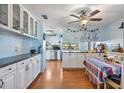 Bright kitchen featuring white cabinets, butcher block countertops, and a spacious dining area at 11296 90Th Ave, Seminole, FL 33772