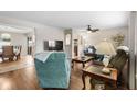 Comfortable living room with hard wood floors, connected to the dining room at 1205 Desert Hills Dr, Sun City Center, FL 33573