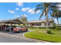 Scenic exterior view showcasing a well-maintained property with a carport and beautiful landscaping at 190 Dale Pl, Oldsmar, FL 34677