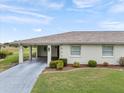 Charming single-story home featuring a well-maintained lawn and inviting carport at 2214 Highclere Cir # 6, Sun City Center, FL 33573