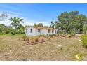 Quaint single-story home featuring a spacious yard with lush, decorative landscaping at 2233 Rightaway Ln, Plant City, FL 33565