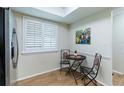 Bright breakfast nook featuring tile floors, a breakfast table, and shutters at 2238 Lark W Cir # D, Palm Harbor, FL 34684