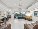 Spacious living room with tile flooring, large windows with a pool view, and modern decor at 2730 River Woods Dr, Parrish, FL 34219