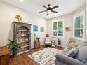 Cozy living room with hardwood floors, a comfortable couch, and a large window for natural light at 2730 River Woods Dr, Parrish, FL 34219