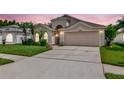 Charming single-Gathering home with a well-manicured lawn and an attached two-car garage at 30445 Tremont Dr, Wesley Chapel, FL 33543