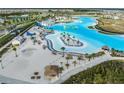 Stunning aerial view of community with white sand beaches, blue lagoon, and waterslides at 30989 Summer Sun Loop, Wesley Chapel, FL 33545