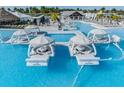Beautiful community pool featuring cozy private cabanas for relaxing in the sun at 30989 Summer Sun Loop, Wesley Chapel, FL 33545