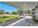 Inviting front porch with a view of the landscaped yard and a peaceful neighborhood street at 3100 70Th N St, St Petersburg, FL 33710