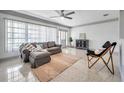 Cozy living room with stylish furniture, neutral tones, and ample natural light from large windows at 3100 70Th N St, St Petersburg, FL 33710