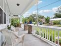 Inviting front porch with comfortable white furniture and nice views of the neighborhood at 311 W Ida St, Tampa, FL 33603