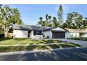 Beautiful single story home featuring an attached two-car garage and a lush green lawn at 34 Harbor Oaks Cir, Safety Harbor, FL 34695