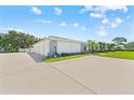 Villa featuring driveway parking, well-maintained landscaping, and inviting curb appeal at 3410 Stonehaven E Ct # A, Palm Harbor, FL 34684