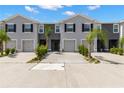Charming two-story townhome with attached garage, manicured landscaping, and inviting curb appeal at 34248 Redwood Dawn Ln, Wesley Chapel, FL 33543