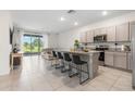 Open-concept kitchen features a large island with barstool seating and overlooks the living area at 34248 Redwood Dawn Ln, Wesley Chapel, FL 33543